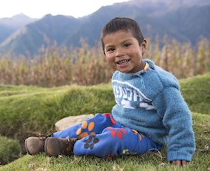 Little boy smiles at the camera.